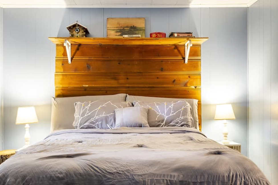 Cozy bedroom with wooden headboard and warm lamps
