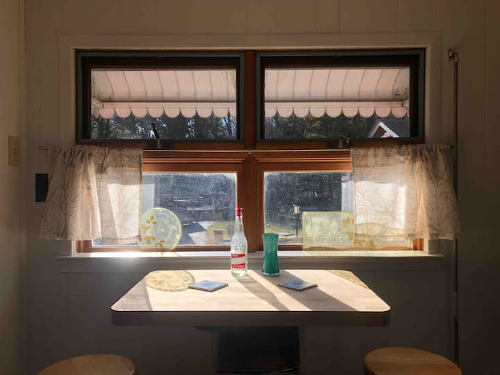 Sunlit breakfast nook with vintage window